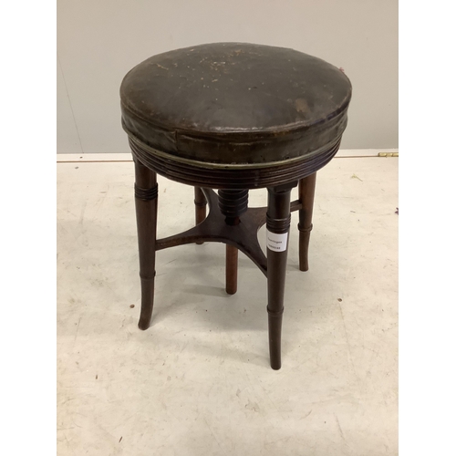 1032 - A Regency mahogany circular adjustable piano stool and a Victorian beech and cast iron piano stool. ... 