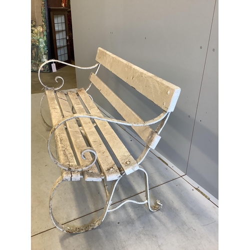 1067 - A white painted slatted wood garden bench with wrought iron ends, width 137cm, depth 63cm, height 78... 