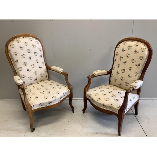 1076 - A near pair of Continental upholstered open armchairs, larger width 67cm, depth 58cm, height 114cm. ... 