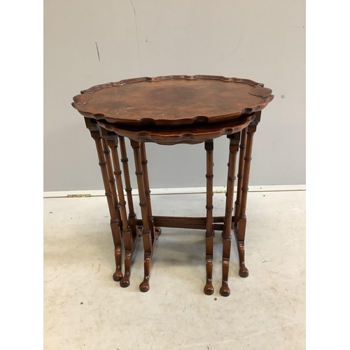 1084 - A nest of three burr walnut oval tea tables, width 56cm, depth 38cm, height 62cm. Condition - fair... 