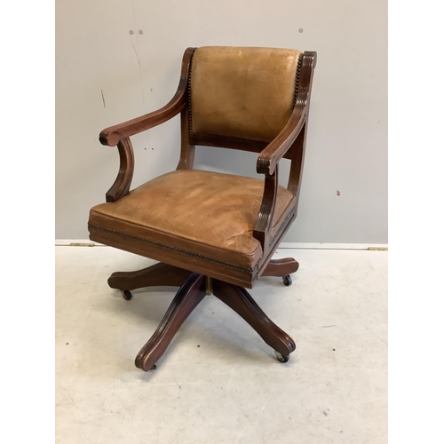 1127 - A reproduction mahogany and tan leather swivel desk chair, width 56cm, depth 52cm, height 84cm. Cond... 