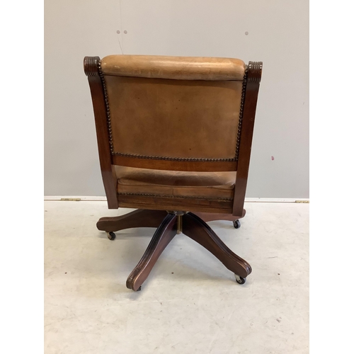 1127 - A reproduction mahogany and tan leather swivel desk chair, width 56cm, depth 52cm, height 84cm. Cond... 