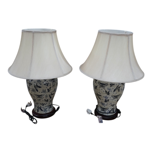 1311 - A pair of Japanese ceramic table lamps, decorated with butterflies, with shades.  Condition - good, ... 