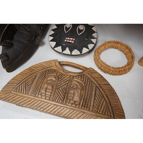 1315 - Three African tribal masks and a carved folding tray, largest 92cm. Condition - fair to good