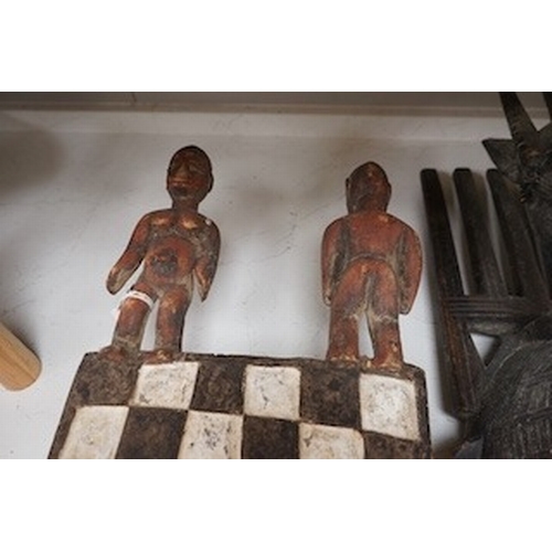 1315 - Three African tribal masks and a carved folding tray, largest 92cm. Condition - fair to good