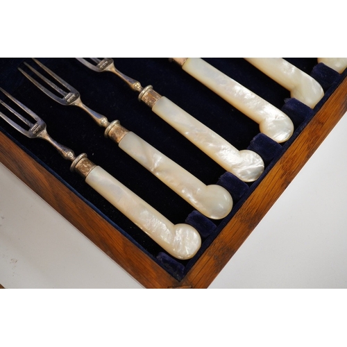 1835 - A cased set of six pairs of late Victorian mother of pearl pistol handled silver dessert eaters, by ... 