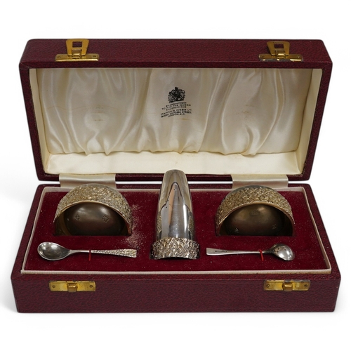 1845 - A cased Elizabeth II parcel gilt silver three piece cruet set, with textured band and two matching s... 