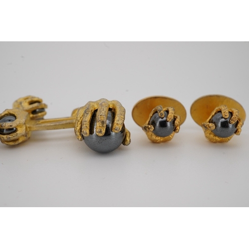 1902 - A modern gilt sterling and hematite set six piece dress stud set, modelled as a hand grasping a sphe... 