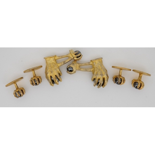 1902 - A modern gilt sterling and hematite set six piece dress stud set, modelled as a hand grasping a sphe... 