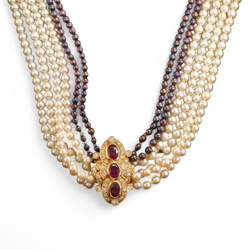 1927 - A cultured pearl, ruby and diamond necklace, the clasp set with oval rubies and brilliant-cut diamon... 