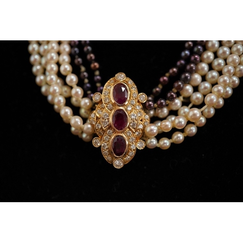 1927 - A cultured pearl, ruby and diamond necklace, the clasp set with oval rubies and brilliant-cut diamon... 