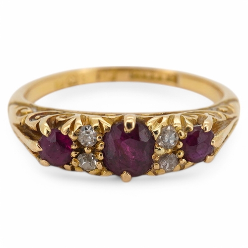 1932 - An Edwardian 18ct gold, three stone ruby and four stone diamond set half hoop ring, size K, gross we... 