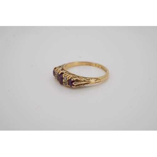 1932 - An Edwardian 18ct gold, three stone ruby and four stone diamond set half hoop ring, size K, gross we... 