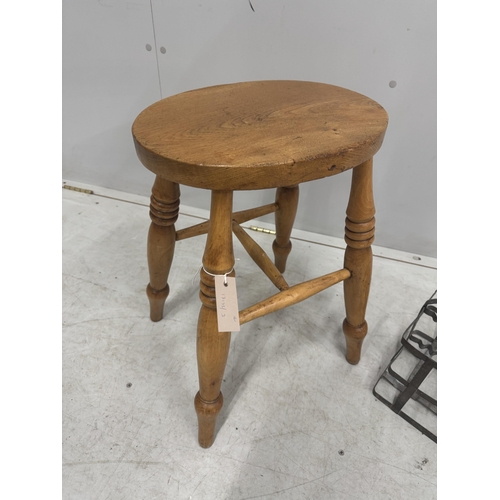 104 - A Victorian elm and beech stool, height 52cm, together with a French galvanised six section bottle c... 