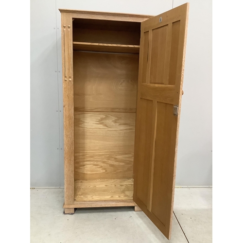 178 - A limed oak four piece bedroom suite, comprising wardrobe, three drawer chest and a pair of single h... 