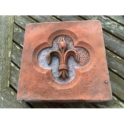 186 - Six terracotta decorative tiles, largest width 21cm. Condition - fair