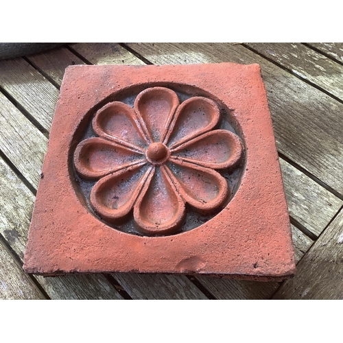 186 - Six terracotta decorative tiles, largest width 21cm. Condition - fair