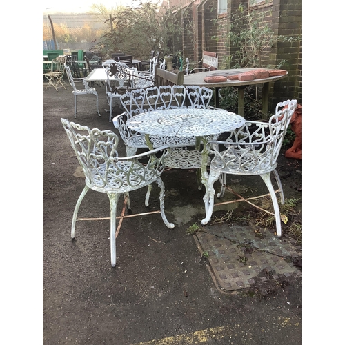 187 - An aluminium garden table, diameter 80cm, height 66cm with two chairs and a bench. Condition - fair... 