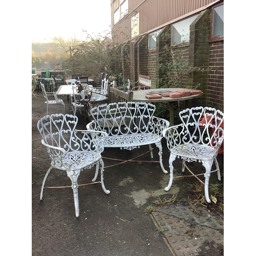 187 - An aluminium garden table, diameter 80cm, height 66cm with two chairs and a bench. Condition - fair... 