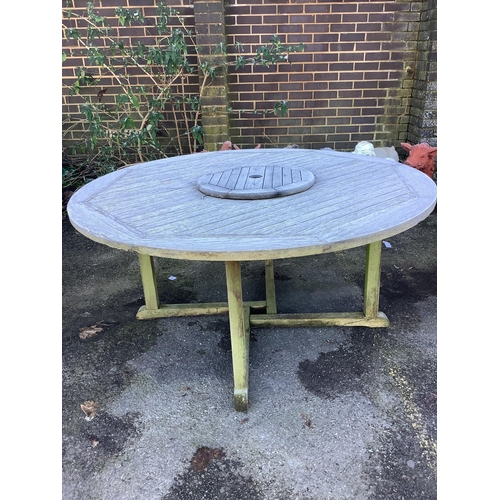 188 - A teak garden bench and a teak circular table, table diameter 148cm, height 70cm. Condition - fair... 