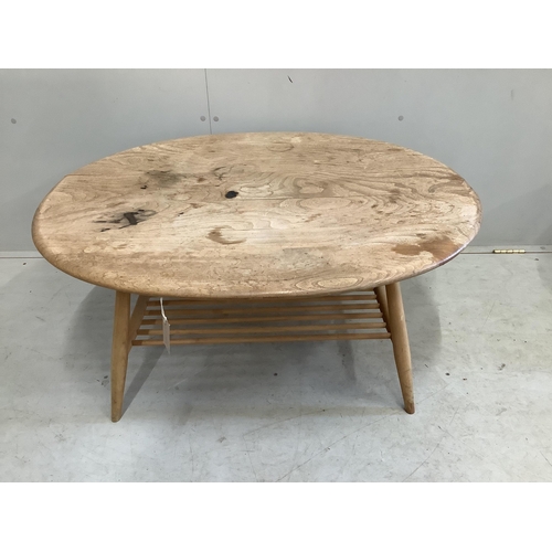 19 - An Ercol oval elm coffee table and a nest of two tables, largest width 98cm, depth 84cm, height 44cm... 