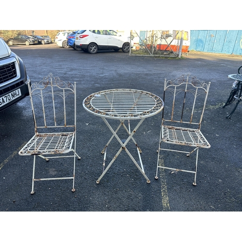 191 - A folding aluminium garden table, diameter 69cm and a pair of folding chairs. Condition - poor... 