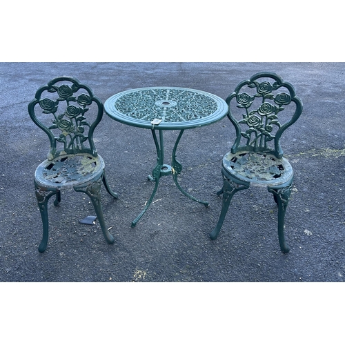 192 - An aluminium garden table, diameter 68cm and a pair of chairs. Condition - poor