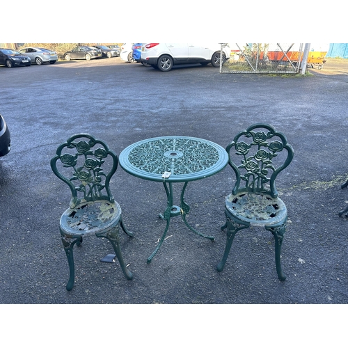 192 - An aluminium garden table, diameter 68cm and a pair of chairs. Condition - poor