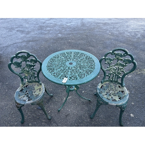 192 - An aluminium garden table, diameter 68cm and a pair of chairs. Condition - poor