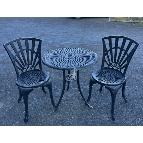 193 - An aluminium garden table, diameter 65cm and a pair of chairs. Condition - poor