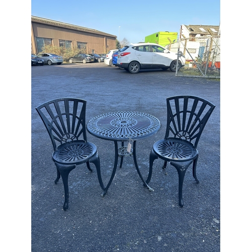 193 - An aluminium garden table, diameter 65cm and a pair of chairs. Condition - poor