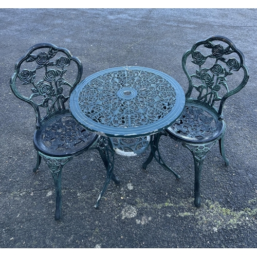 194 - An aluminium garden table, diameter 60cm and a pair of chairs. Condition - poor