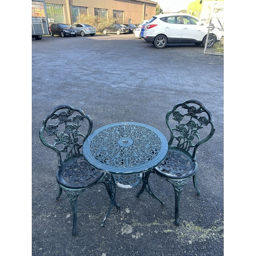 194 - An aluminium garden table, diameter 60cm and a pair of chairs. Condition - poor