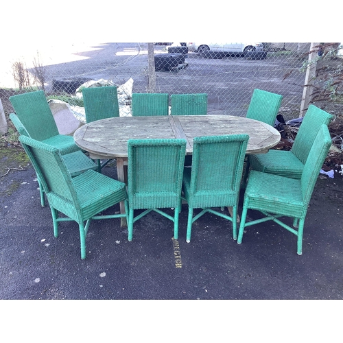 196 - A weathered teak garden table, width 180cm, depth 99cm, height 75cm and eleven Habitat wicker chairs... 