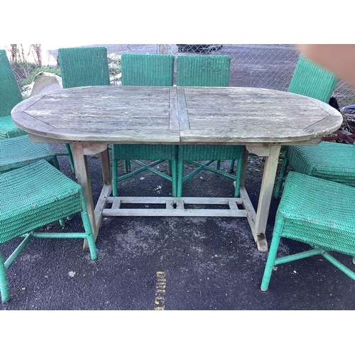 196 - A weathered teak garden table, width 180cm, depth 99cm, height 75cm and eleven Habitat wicker chairs... 