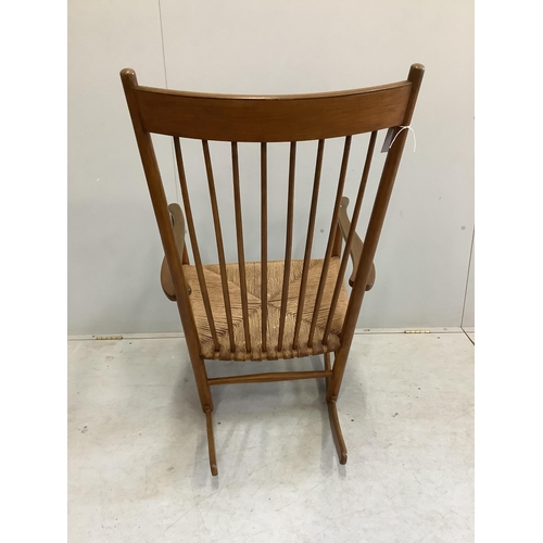 20 - A Hans Wegner style rocking chair, width 63cm, height 106cm. Condition - fair