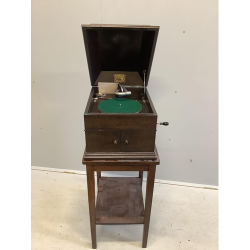 86 - An HMV oak cased table-top gramophone on associated stand together with a collection of 78rpm record... 