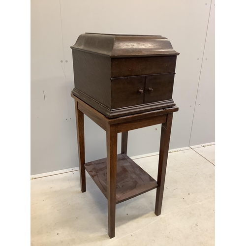 86 - An HMV oak cased table-top gramophone on associated stand together with a collection of 78rpm record... 