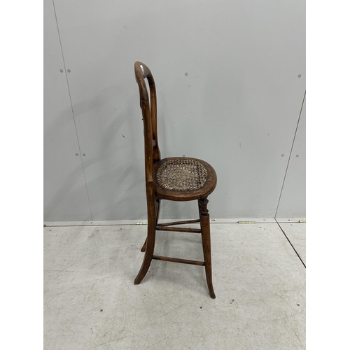 1020 - A Victorian beech cane seat correction chair, height 96cm. Condition - fair