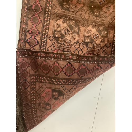 1052 - An Afghan red ground rug, 190 x 120cm. Condition - fair