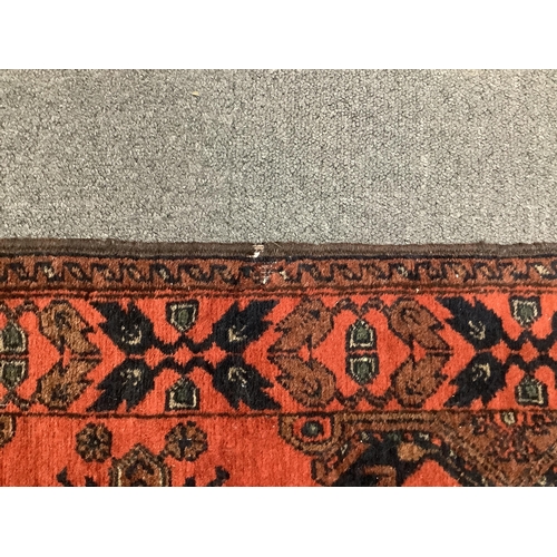 1106 - A large Pakistani Bokhara motif hand-knotted wool red ground runner, approx. 950 x 72cm. Condition -... 