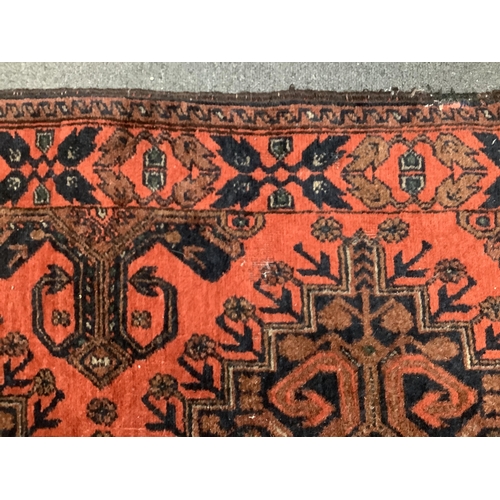 1106 - A large Pakistani Bokhara motif hand-knotted wool red ground runner, approx. 950 x 72cm. Condition -... 