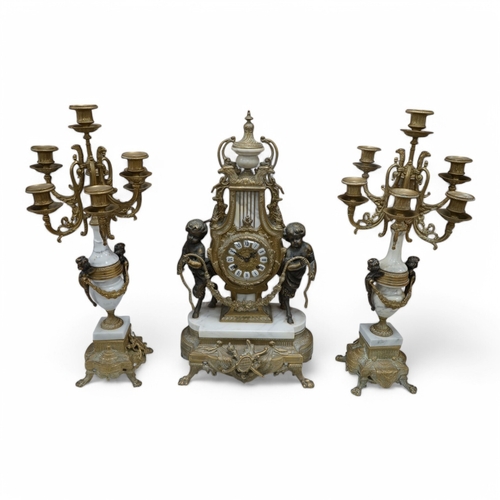 1618 - A gilt metal and marble clock garniture, with key, 61cm. Condition - fair/good