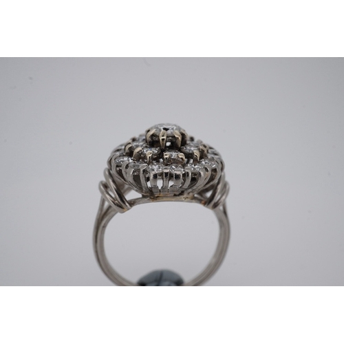 1924 - A white metal and diamond cluster set dress ring, with 'wire work' shoulders, size H, gross weight 5... 