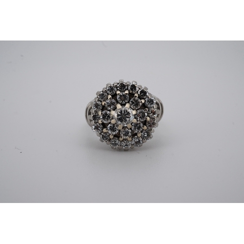 1924 - A white metal and diamond cluster set dress ring, with 'wire work' shoulders, size H, gross weight 5... 