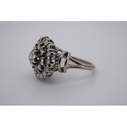 1924 - A white metal and diamond cluster set dress ring, with 'wire work' shoulders, size H, gross weight 5... 