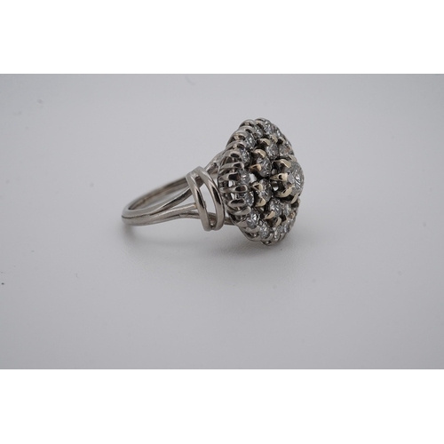 1924 - A white metal and diamond cluster set dress ring, with 'wire work' shoulders, size H, gross weight 5... 