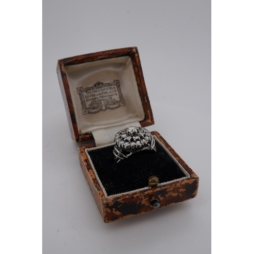 1924 - A white metal and diamond cluster set dress ring, with 'wire work' shoulders, size H, gross weight 5... 