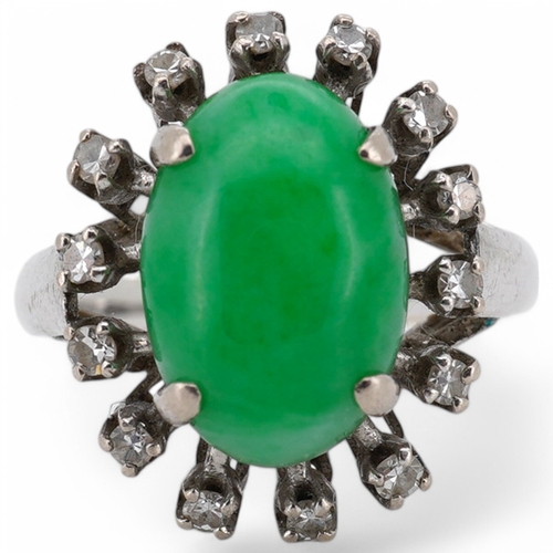 1928 - A white metal and cabochon jade set ring, with round cut diamond set border, size N, gross weight 5.... 