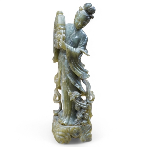 415 - A Chinese carved green soapstone figure of Guanyin, 34cm high. Condition - fair to good